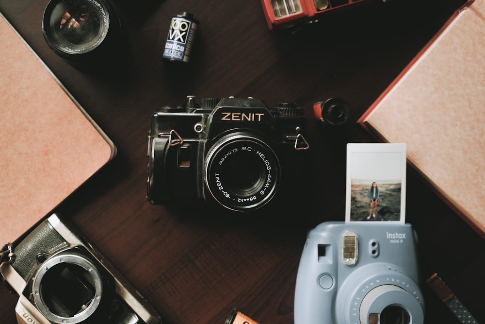 black and silver nikon camera on brown wooden table