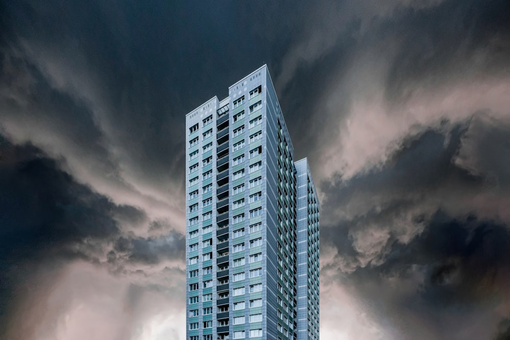 gray and white high rise building under gray clouds