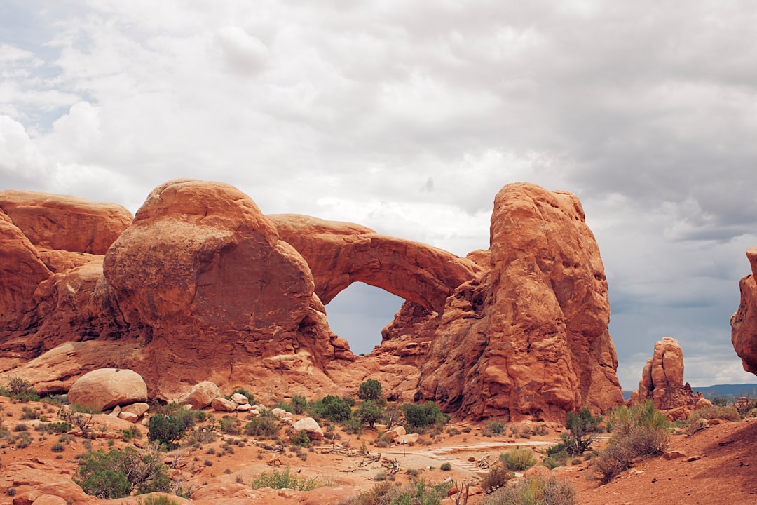 brown rock formation under white clouds during daytime