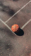 brown basketball on gray concrete floor