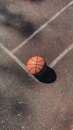 brown basketball on gray concrete floor