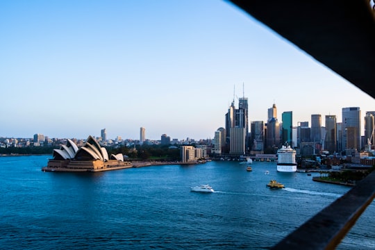 white and black boat on body of water near city buildings during daytime in Sydney Opera House Australia