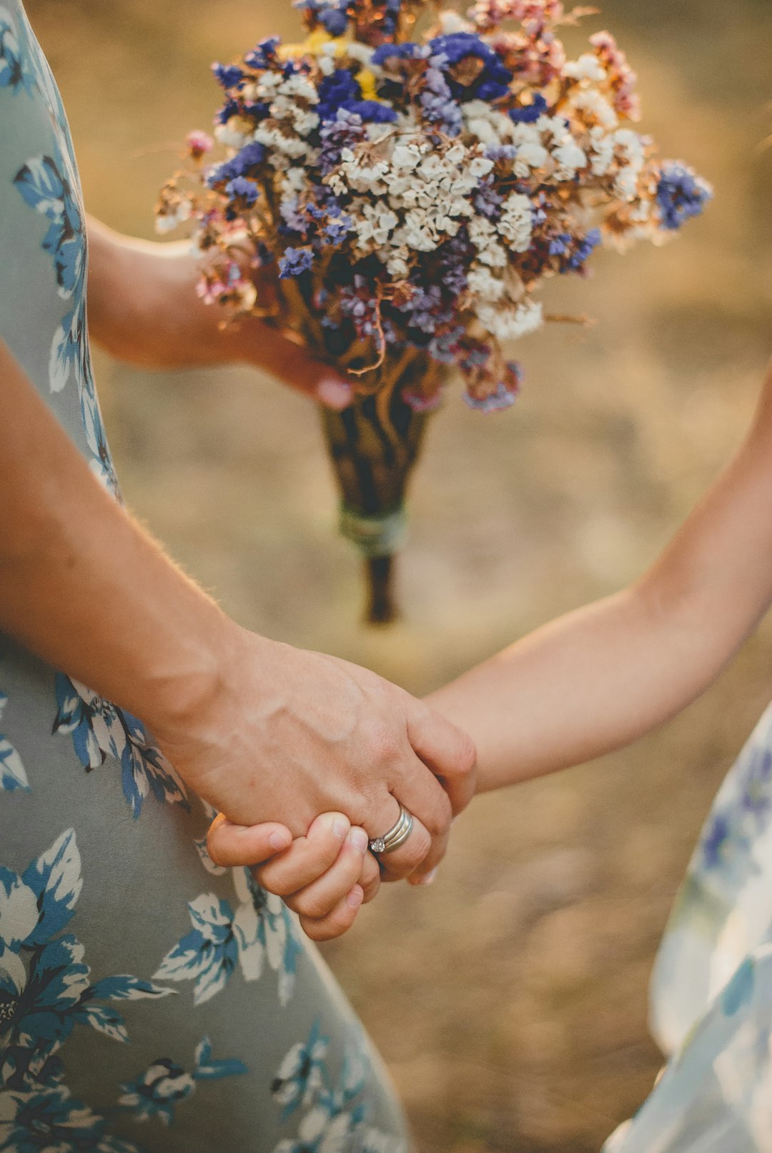 person holding purple and white flowers