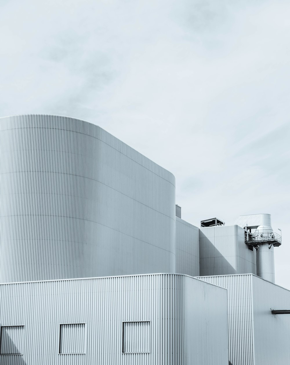 white concrete building under white sky during daytime