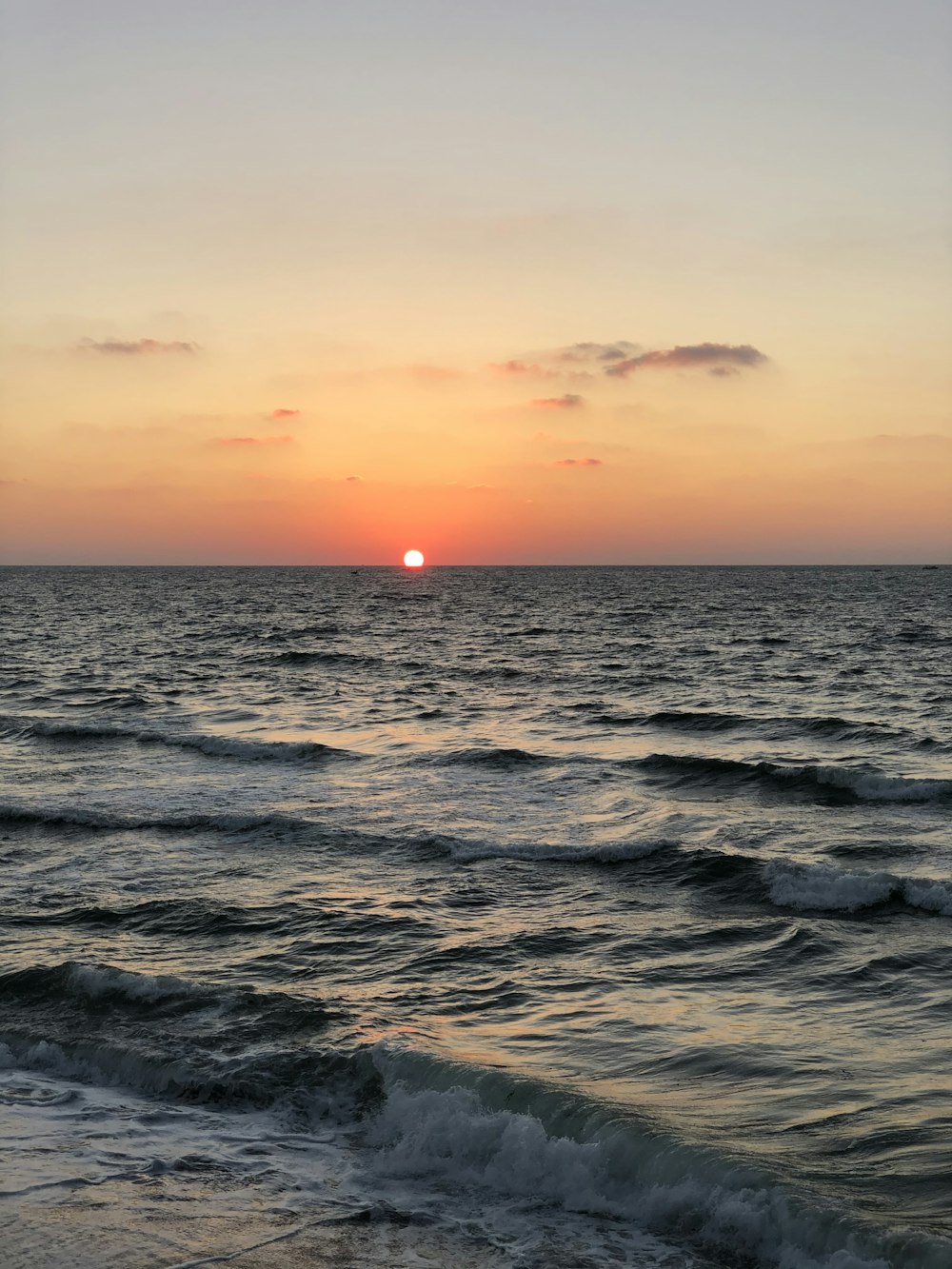 body of water during sunset