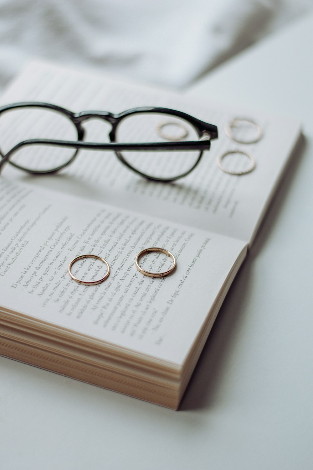 black framed eyeglasses on white book page