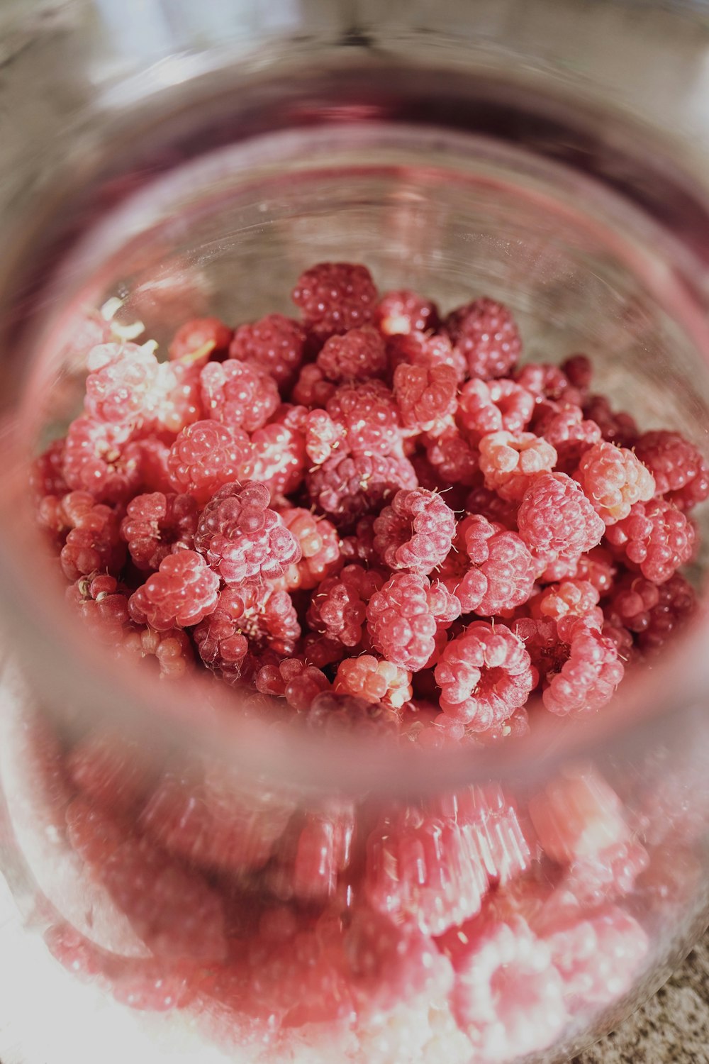 red round fruits in clear glass bowl