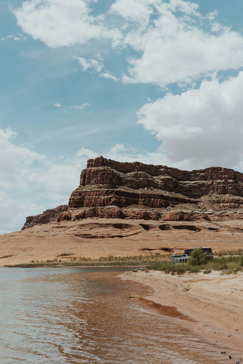 brown rock formation near body of water during daytime