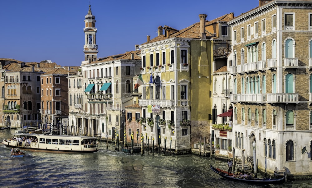 boat on river between buildings during daytime