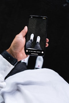 person holding black iphone case