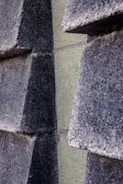 Close-up of textured concrete grey background with subtle beige storytelling blocks.