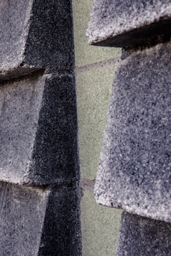 Close-up of textured concrete grey background with subtle beige storytelling blocks.