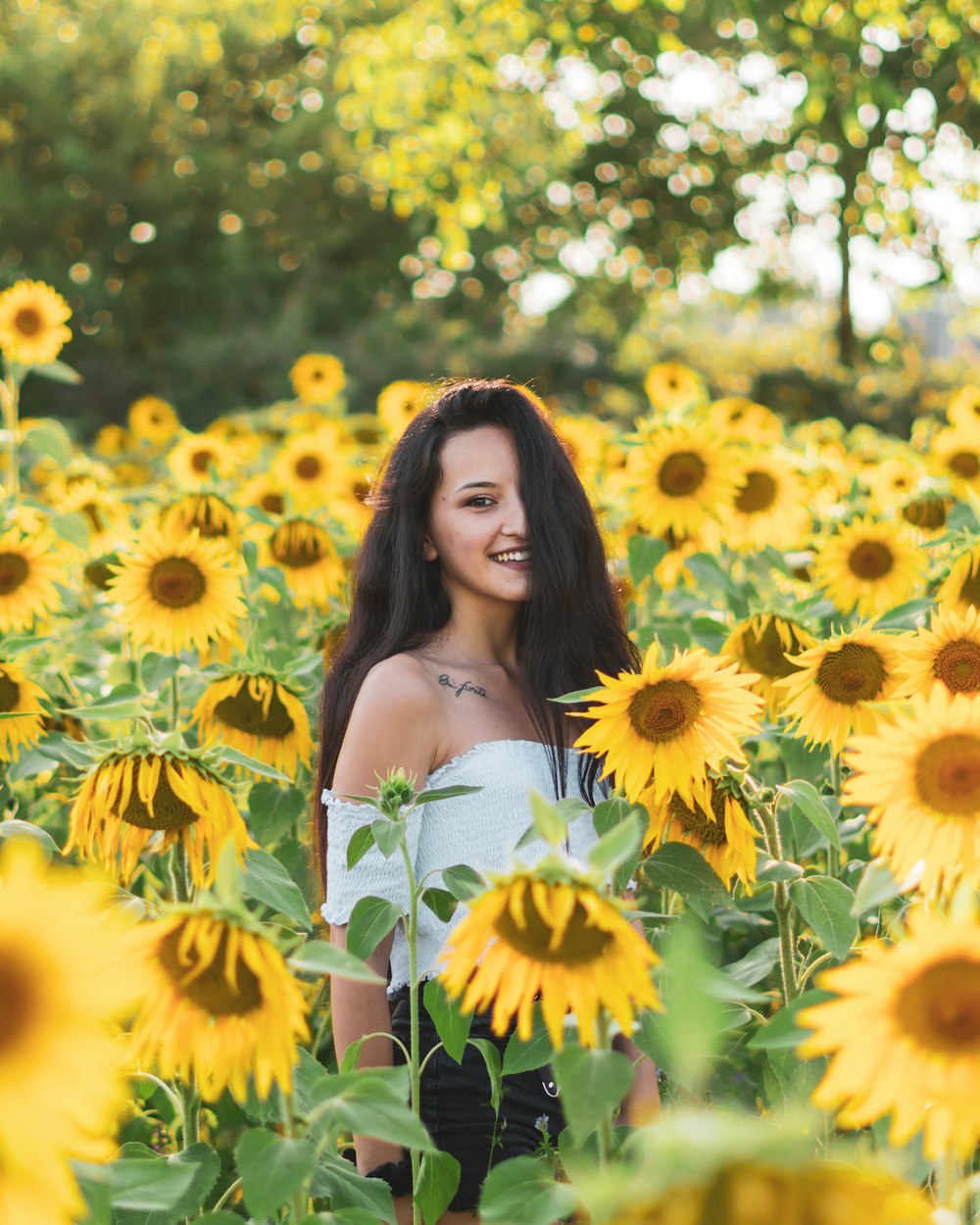woman in white tube dress surrounded by yellow flowers