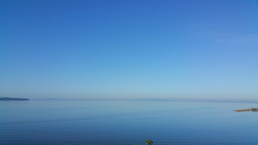 blue sky over body of water
