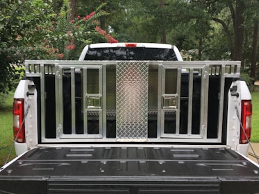 Side view of a custom upfitted truck with secure storage compartments and mounted equipment.
