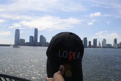 Close-up of a fan proudly wearing a Steelers cap with the city skyline in the background.