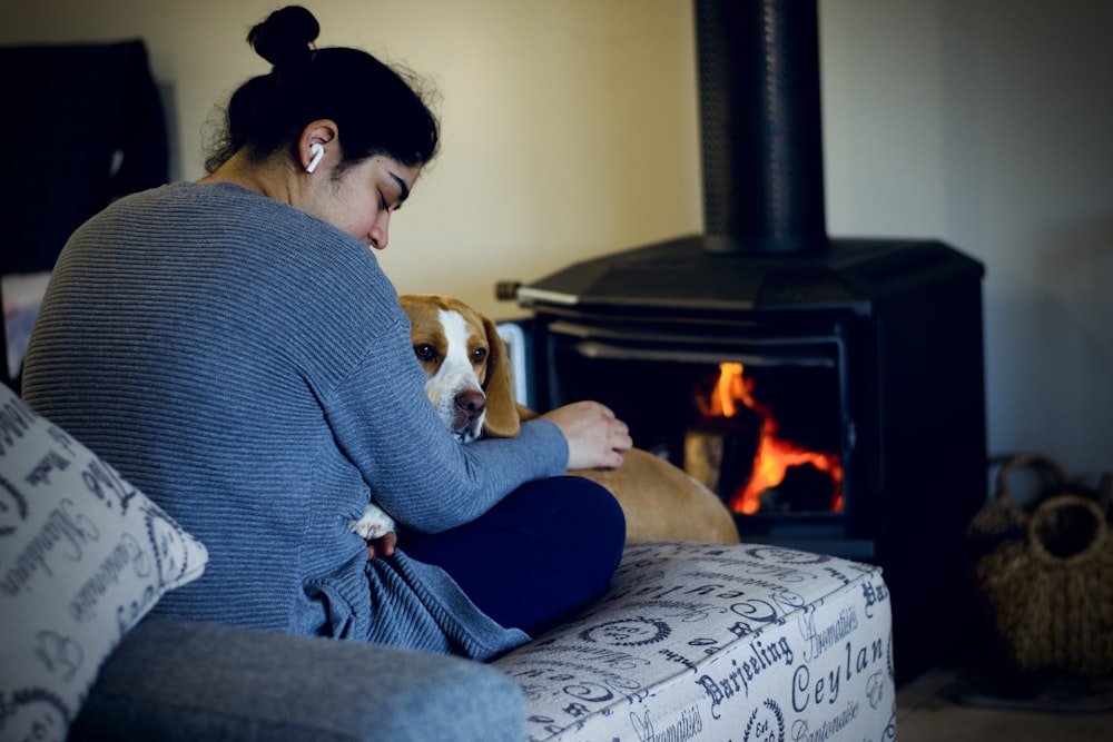 woman in blue sweater sitting on couch