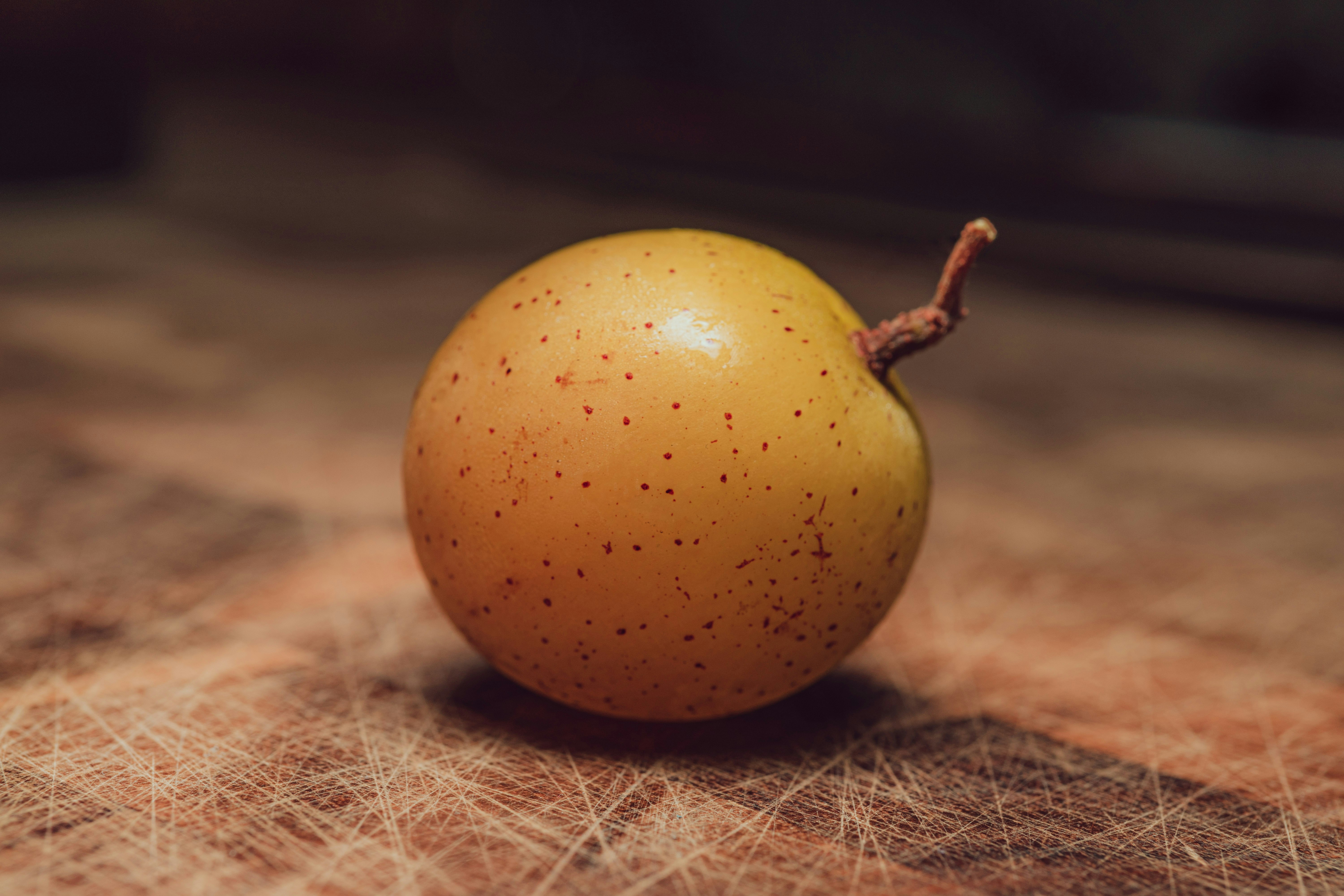 yellow round fruit on brown textile