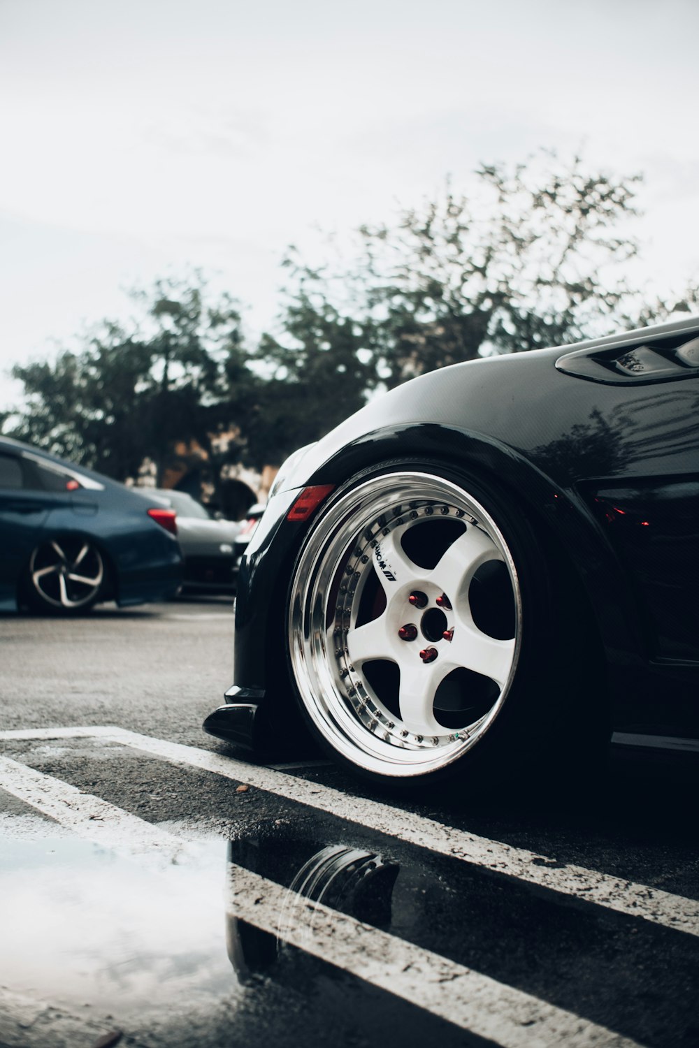 black car with white wheel on the road