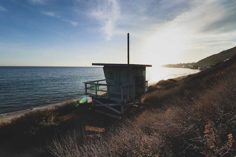 brown wooden lifeguard house on seashore during daytime