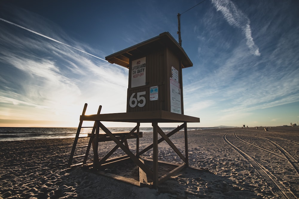 brown wooden lifeguard tower on beach during daytime