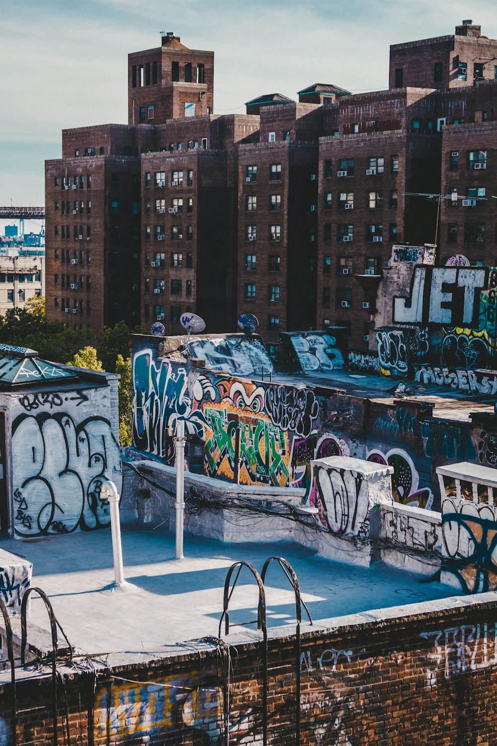 black metal chairs and table near blue and white wall with graffiti