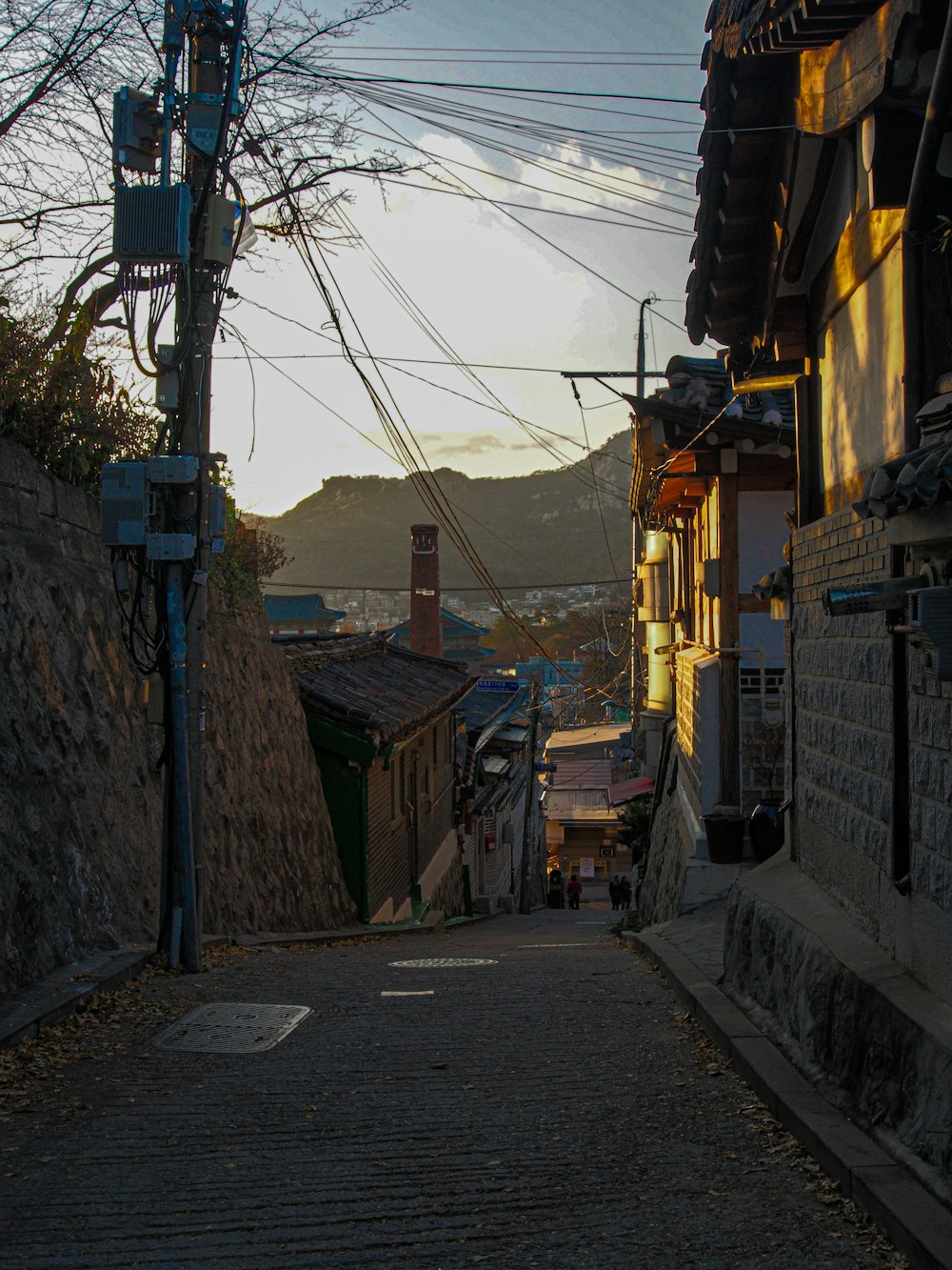 brown wooden houses near road during daytime