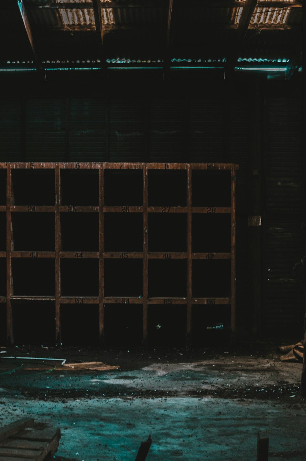 brown wooden door on black concrete wall