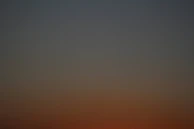 Soft gradient of deep charcoal fading into warm gold, suggesting dawn or new beginnings.