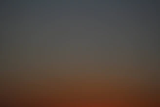 Soft gradient of deep charcoal fading into warm gold, suggesting dawn or new beginnings.