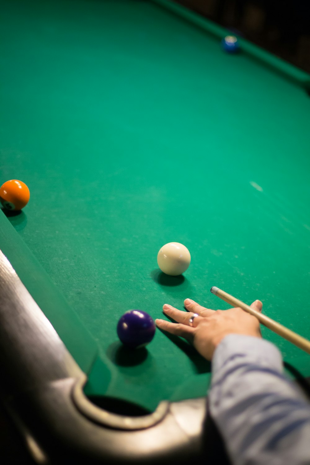 2 white and blue billiard balls on green billiard table