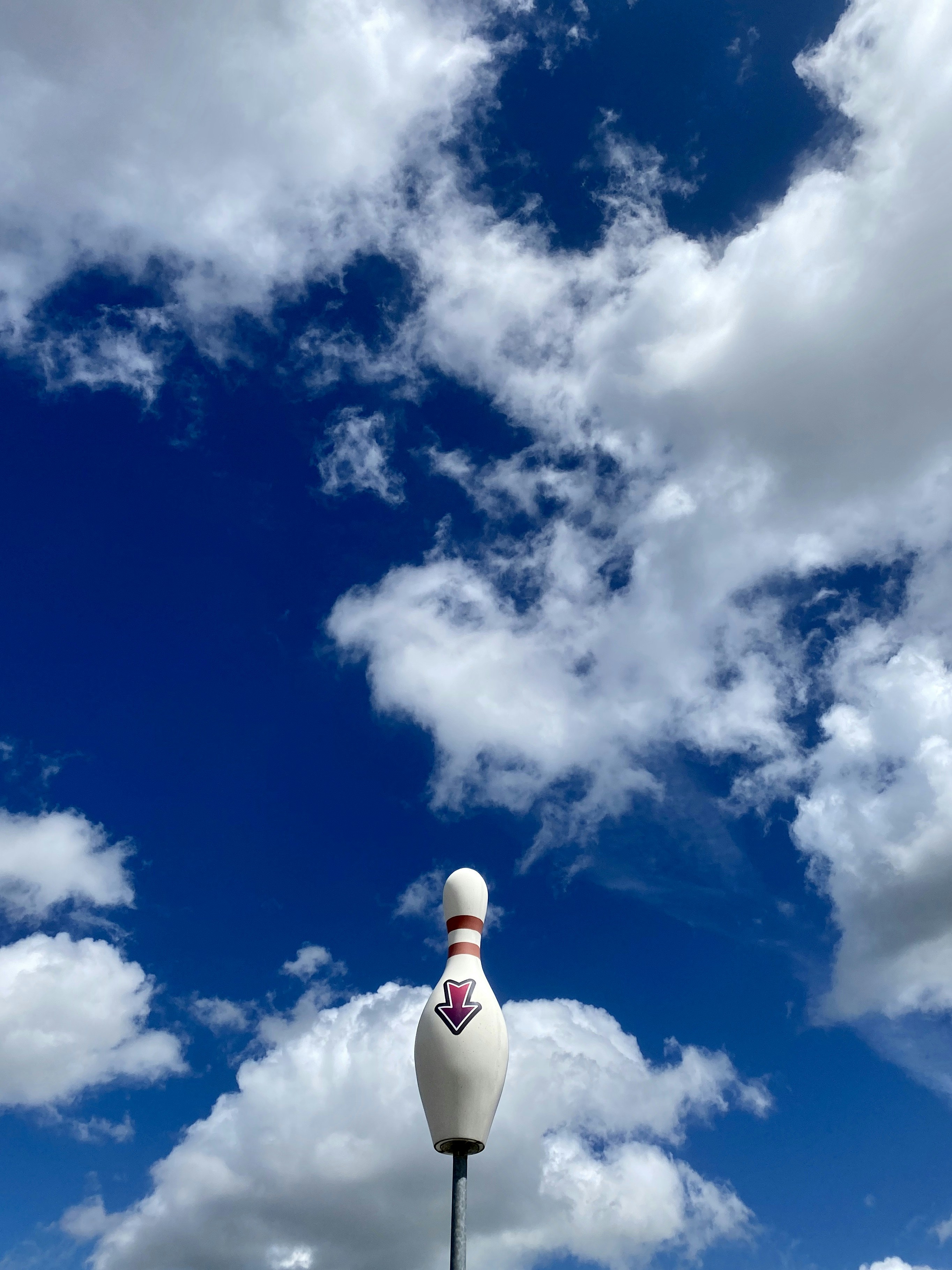 Bowling pin against a cloudy sky