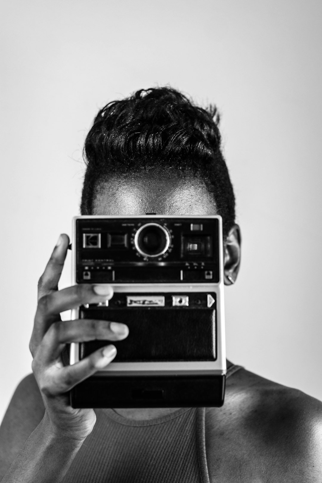 grayscale photo of man holding vintage camera