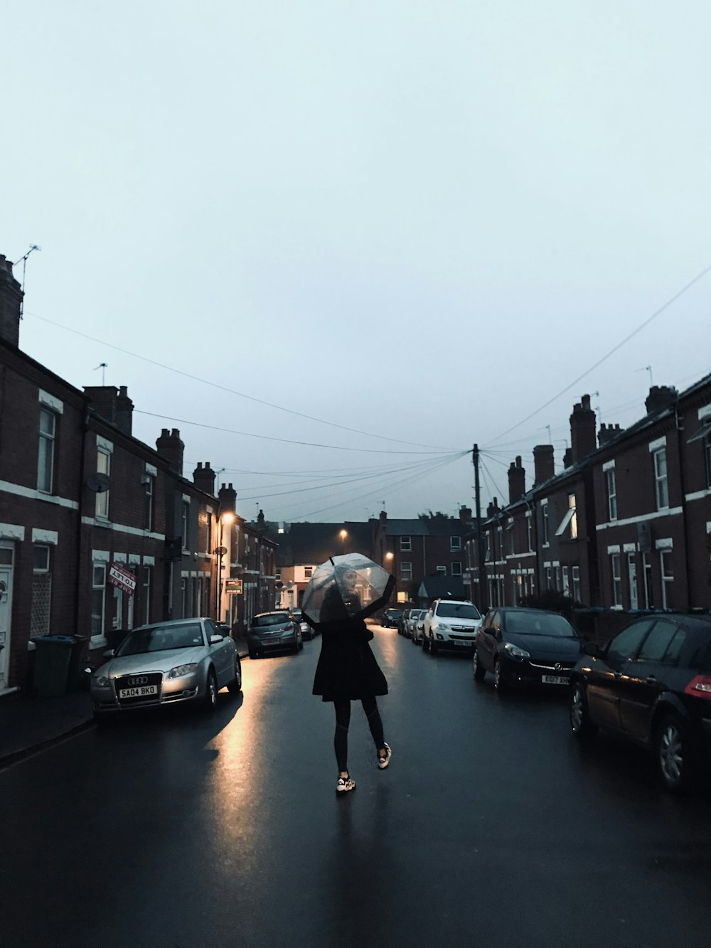 woman in black jacket and black pants walking on sidewalk during daytime