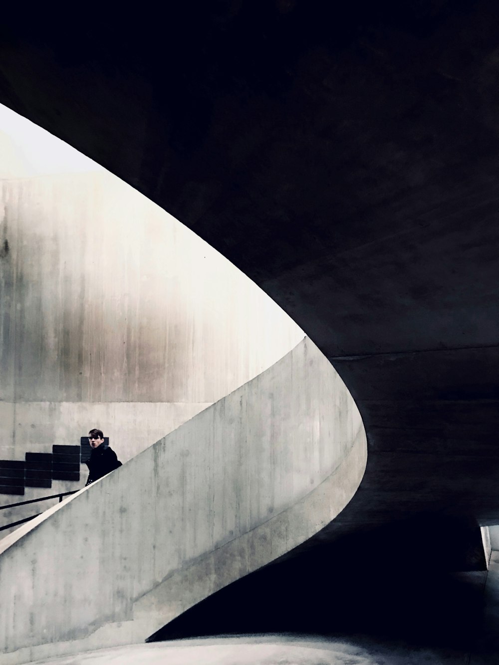 man in black jacket standing on stairs