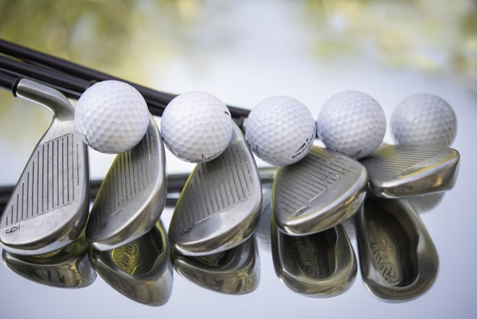 Golf wedges and balls shot close up.