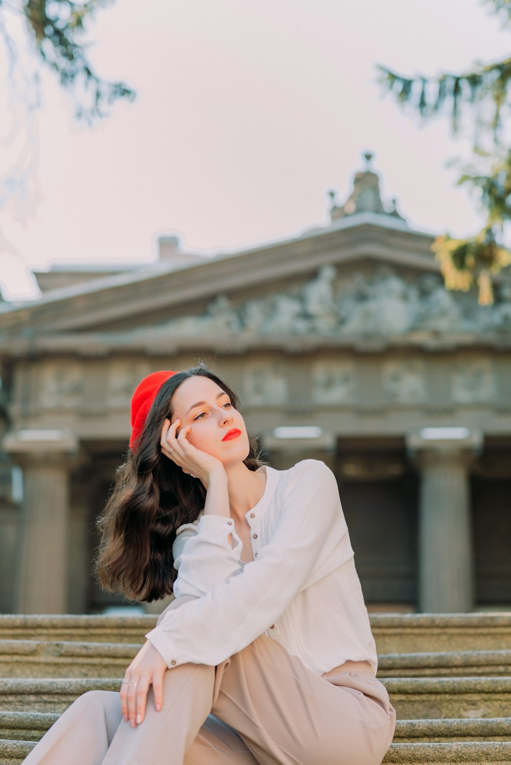 woman in white long sleeve shirt wearing red knit cap