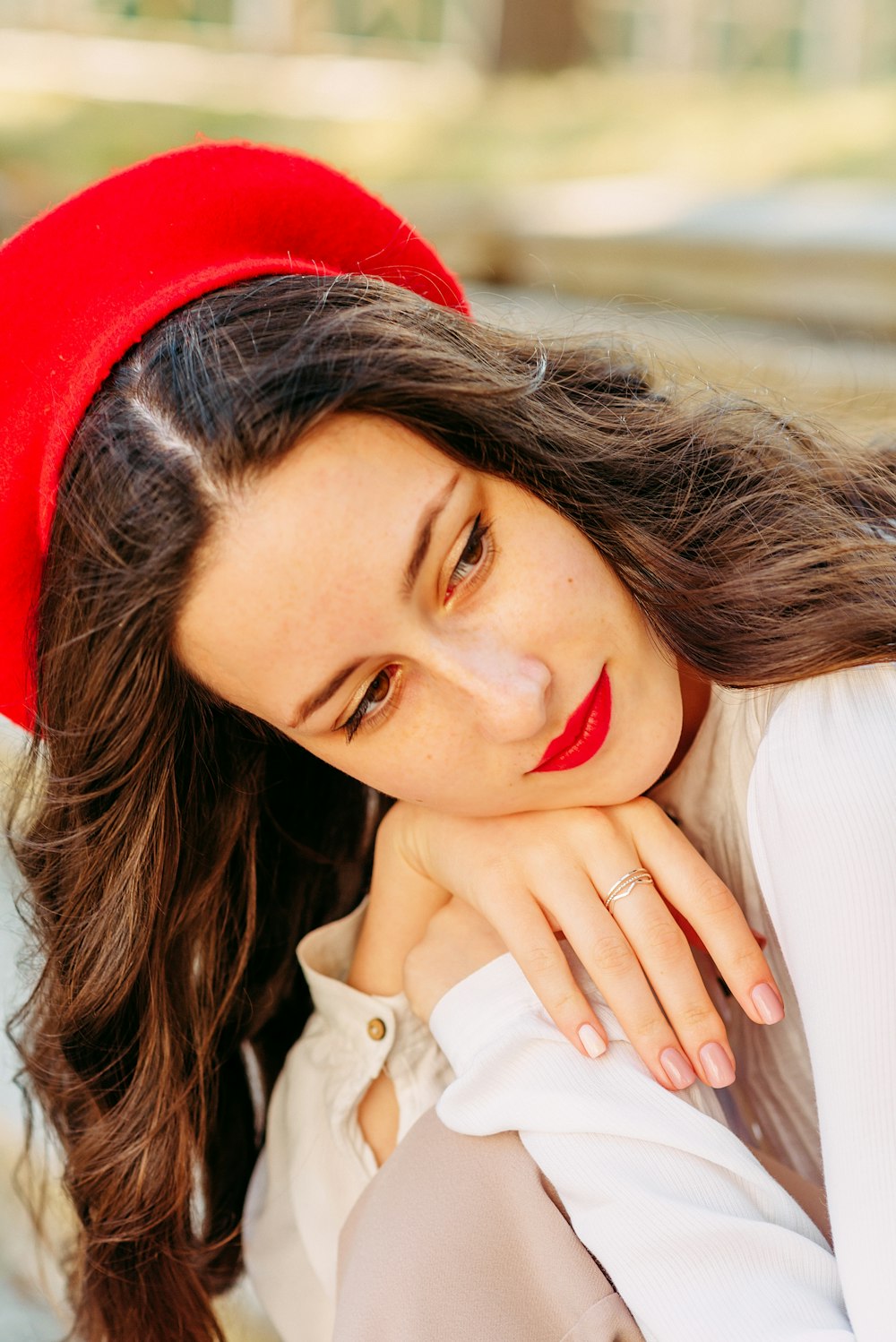 woman in white button up shirt wearing red hat