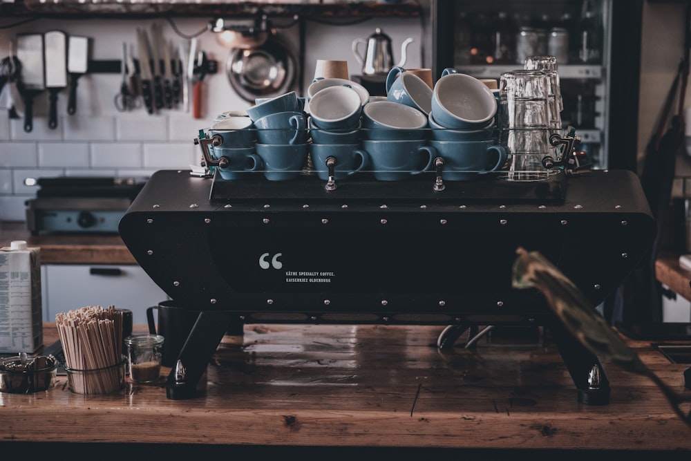 white ceramic mugs on black wooden table