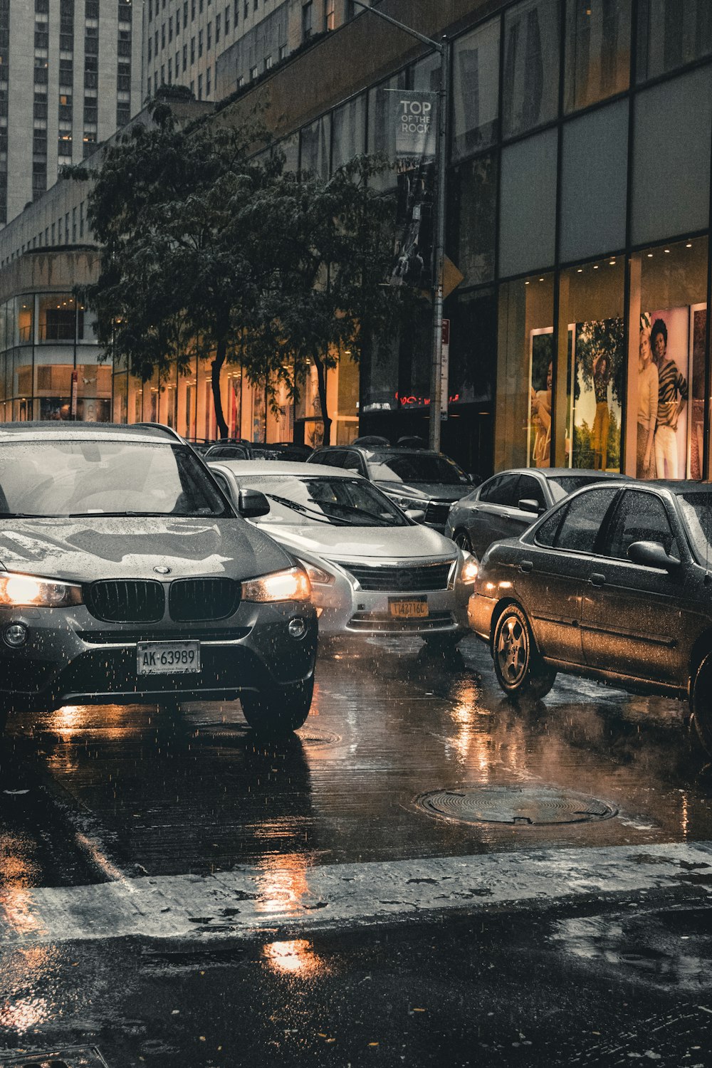 black mercedes benz c class parked on sidewalk during daytime