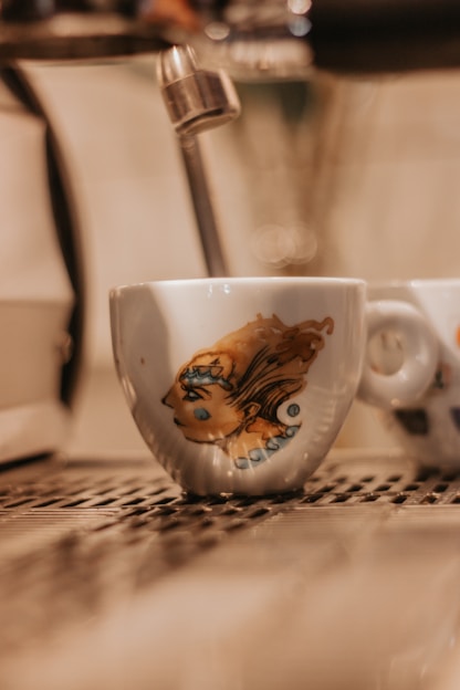 Close-up image of a sleek coffee cup featuring detailed custom graphic design with a QR code.