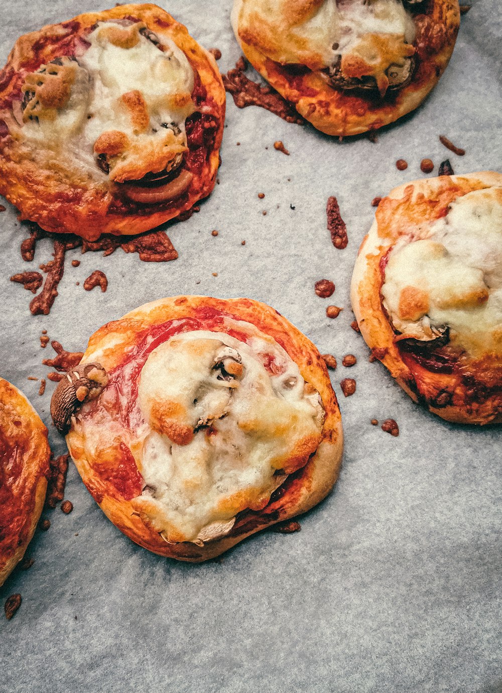 brown and white pizza on gray textile