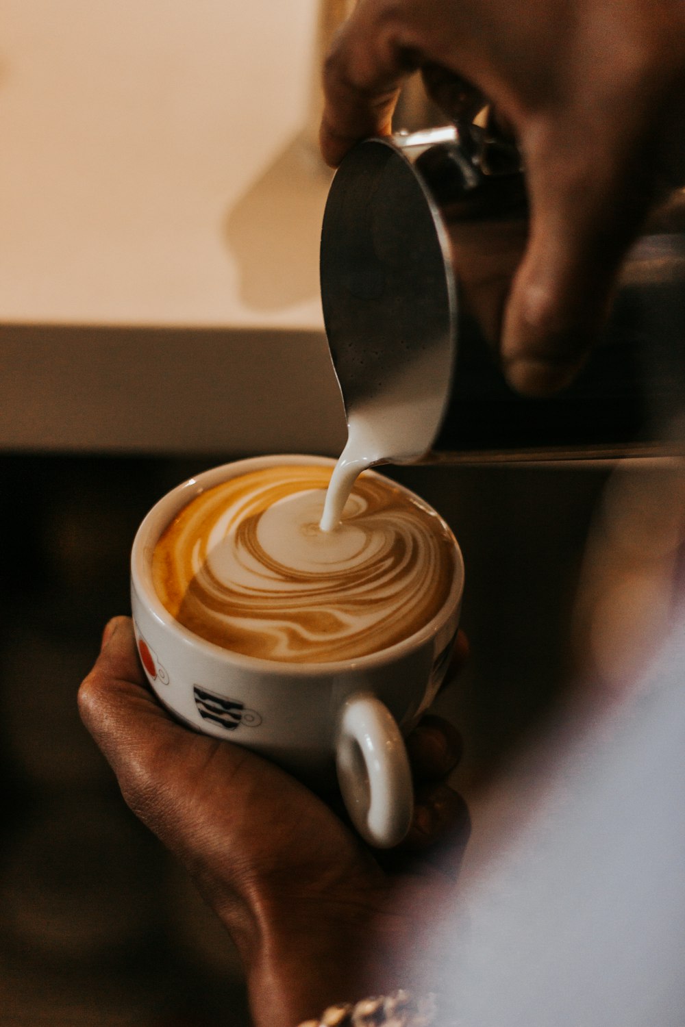 person holding white ceramic mug with coffee