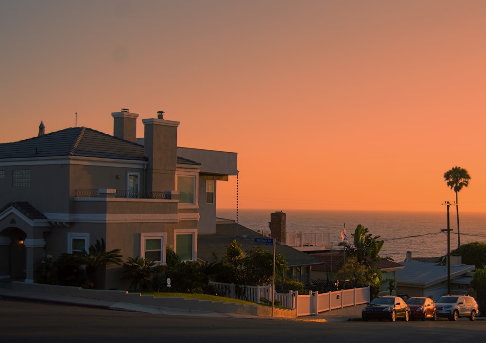 white and brown concrete building near green trees during sunset