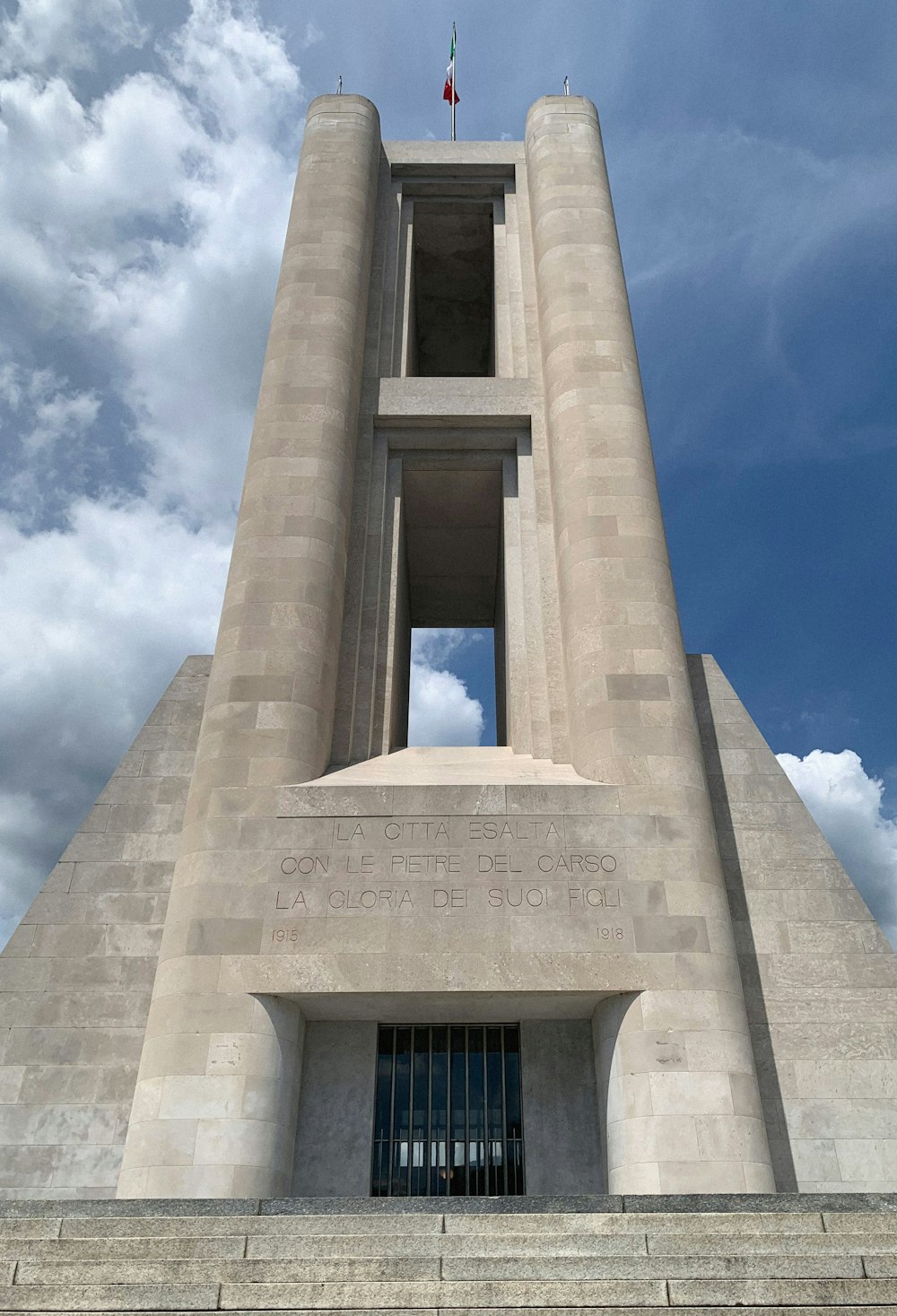 low angle photography of concrete building under blue sky during daytime