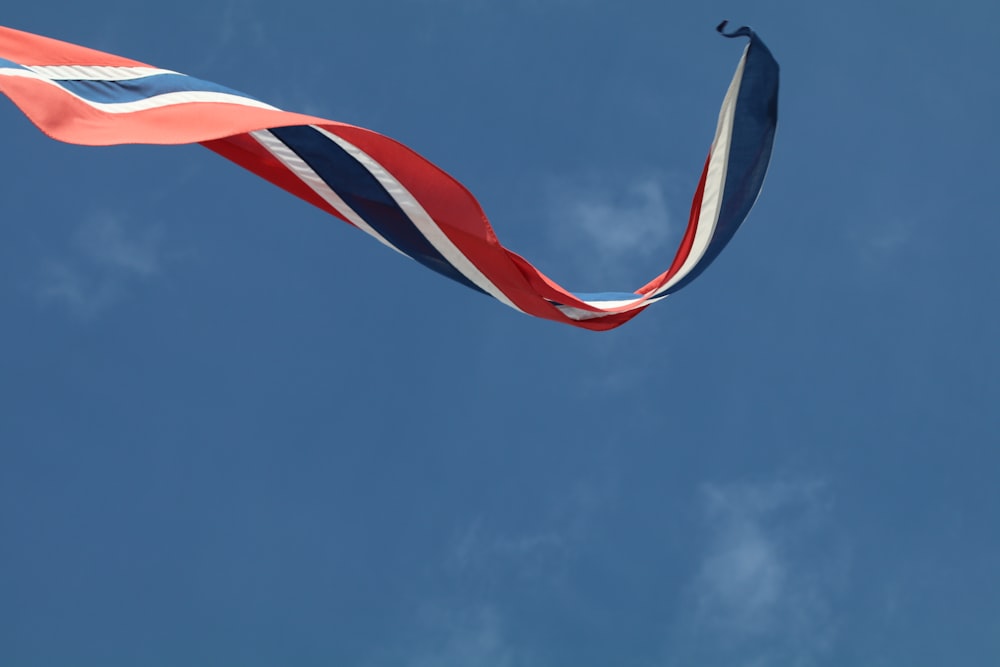 red and white flag under blue sky