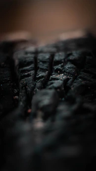 Close-up shot of a textured surface with dramatic shadows and contrast.