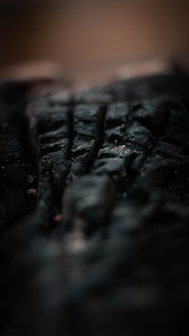 Close-up of a textured surface featuring deep black shades and subtle lighting.