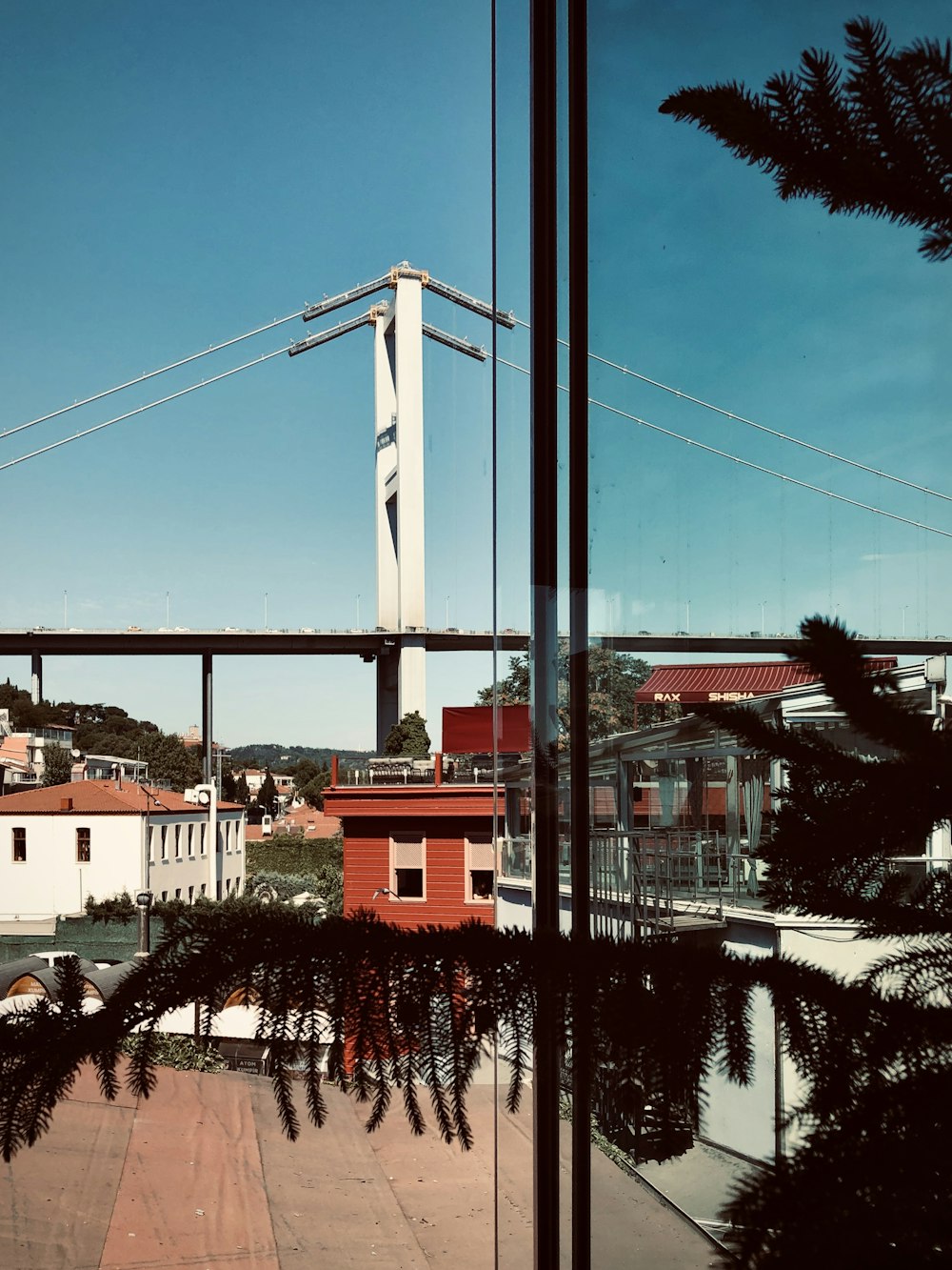 white and brown concrete building near bridge under blue sky during daytime