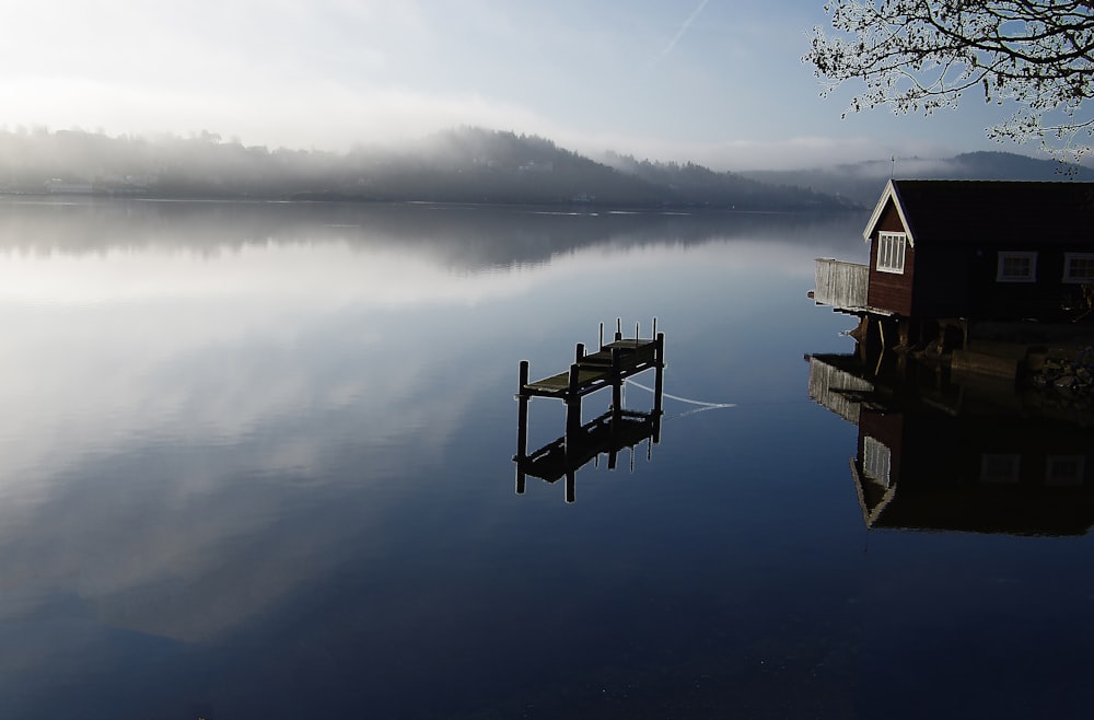 brown wooden dock on lake during daytime